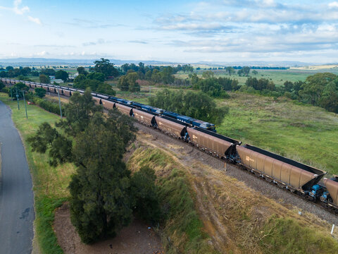 Train full of coal and empty train passing one another on railway