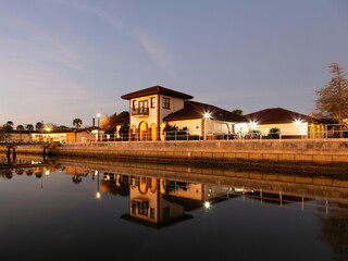 Fototapeta premium Waterfront Spanish style buildings and their reflection in the Matanzas Bay and harbour at sunset, St. Augustine, Florida