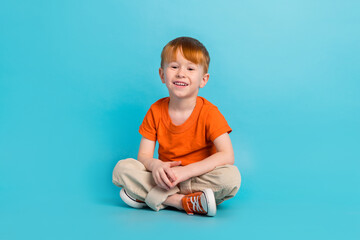 Portrait of glad charming boy rejoice good mood comfort modern outfit isolated on cyan color...