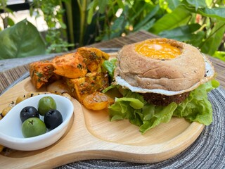 Egg bagel burger with falafel, tofu masala and chic pea with olive