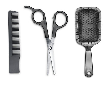 Hair cutting shears, hairbrush and comb isolated