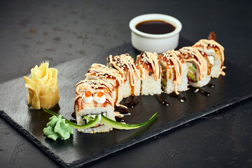 Roll made of Fresh Raw Salmon, Smoked Eel, Cream Cheese and Avocado inside. Topped with Smoked Eel unagi