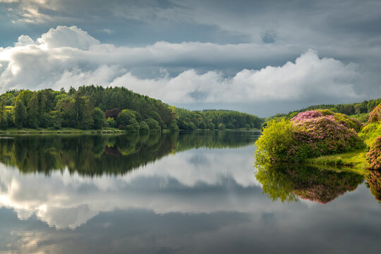Reflections on a calm summer evening at Kennick Reservoir, Dartmoor National Park, Devon