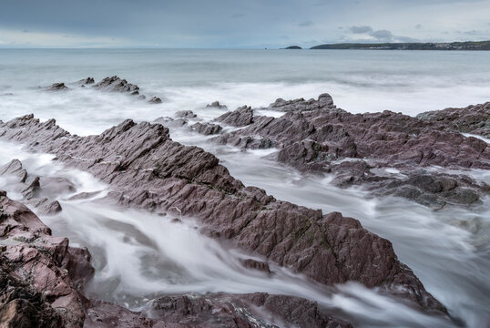 Stormy seas over rocky shores of Downderry Beach, in spring, Cornwall