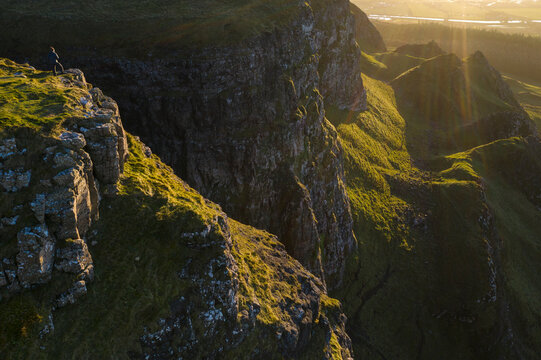 Man standing on the cliff edge of Binevenagh mountain, County Antrim, Ulster, Northern Ireland