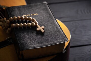 Holy Bible with retro acoustic guitar, music religion concept