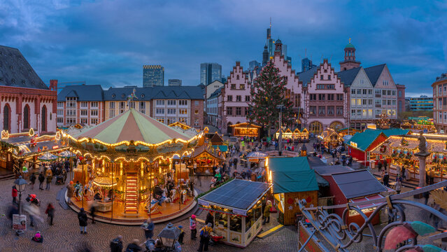 View of carousel and Christmas Market stalls at dusk, Roemerberg Square, Frankfurt am Main, Hesse, Germany