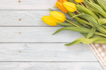 Tulip flowers on wooden table, top view, flat lay background