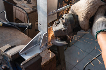 Craftsman working with iron grinding tools