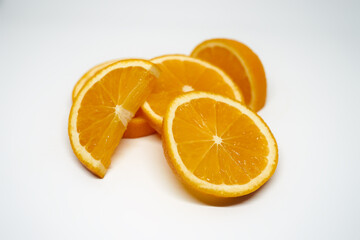Five slices of ​​orange on white isolated studio background side view