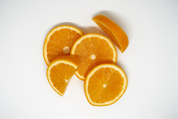 Five slices of ​​orange on white isolated studio background top view