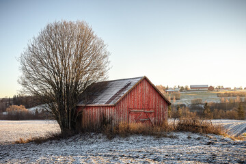 a red shed in the fields