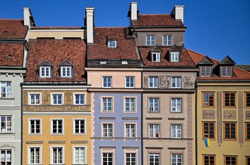 Fototapeta premium The Ukrainian flag hangs from the window of the house.The Ukrainian flag is a symbol of the country's national identity and independence.