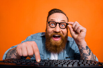 Portrait of crazy geek developer using computer coding searching web shopping sales isolated on shine color background