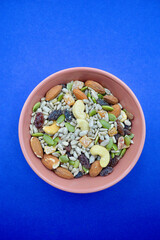 A bowl with mixed seeds, nuts and fruits