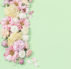 Naklejka na ściany i meble frame of flowers on green background