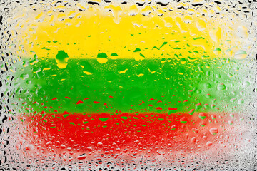 Flag of Lithuania. Lithuania flag on the background of water drops. Flag with raindrops. Splashes on glass