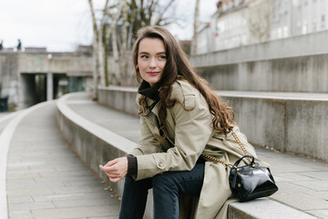Fototapeta premium Young beatiful woman portrait in the historical city centre of Ljubljana in trendy outfit
