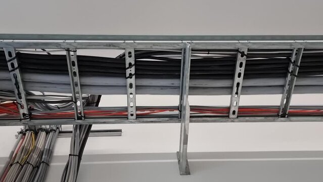 Power and data cables run along the ceiling to safely connect devices, reduce cable clutter, and enhance aesthetics.