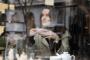 Fashion woman portrait of young pretty trendy girl posing at the city in Europe,summer street fashion, holding a blank shopping bag. Happy customer concept