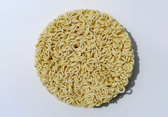 Raw instant noodles on white background - round instant noodles