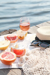 Romantic sunset dinner on the beach. Table honeymoon set for two with luxurious food, glasses of rose wine drinks in a restaurant with sea view. Summer love, romance date on vacation concept.   