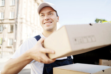 The courier guy is a hack job working for a fast delivery company, a man in the city carrying boxes to the customer at home.