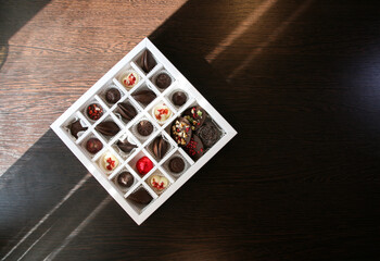 A box of handmade chocolates of different colors