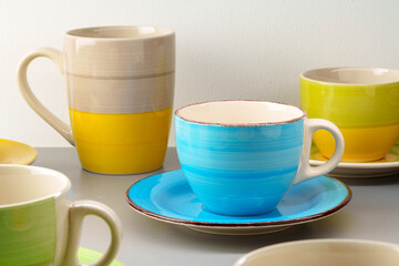 Colorful clay ceramic cups on gray background