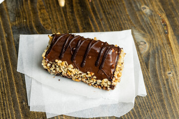 Fresh sweet cake with banana in chocolate glaze and milk filling