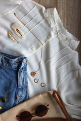 White blouse, denim skirt, vintage bag, sunglasses, pearl barrettes and gold jewelry. Top view.