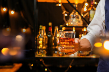 Bartender pouring Whiskey, on  bar