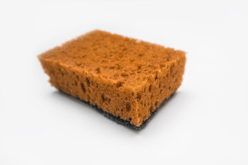 Orange colored used kitchen sponge isolated on white background. Kitchen utensils and domestic chores concept.