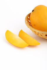 Naklejka na ściany i meble Mango fruit in basket with slice on white background