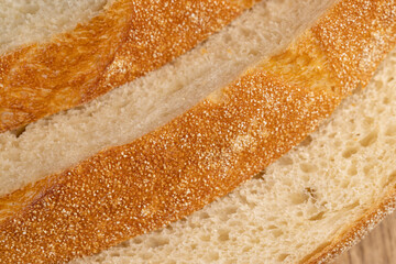 A cut loaf of round-shaped wheat bread