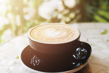 Cup of on the table, coffee shop background, warm tone