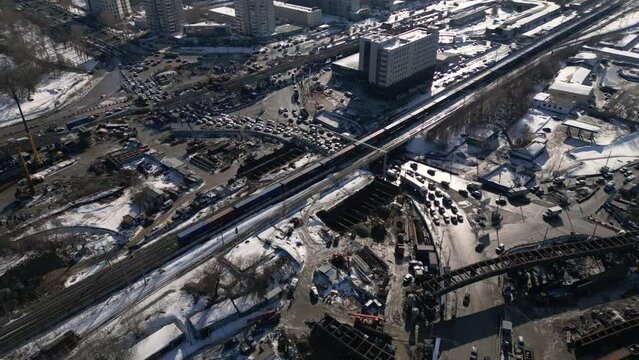 Aerial view from above to the road traffic in a big city on the sunny day. Traffic jam at a highway junction.