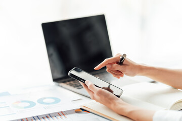beautiful of Asian finger women work with laptop and smartphone in the office.