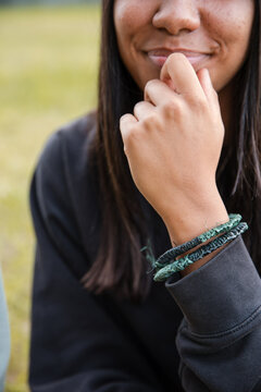 An Aboriginal girl wearing traditional, fibre, woven bracelets
