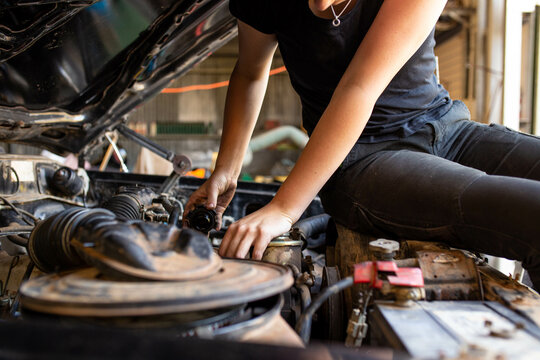 Young Australian Tradesperson Mechanic Fixing Car Engine In Automotive Repair Garage