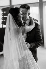 Fototapeta premium the first dance of the bride and groom inside a restaurant