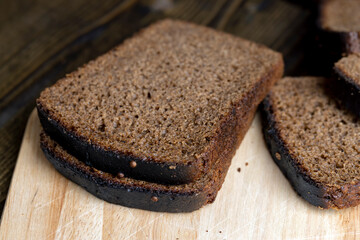 Square loaf of black rye bread Cut into pieces