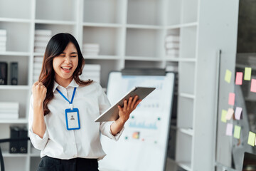 Young woman happy and screaming because of problems with documents in the office.