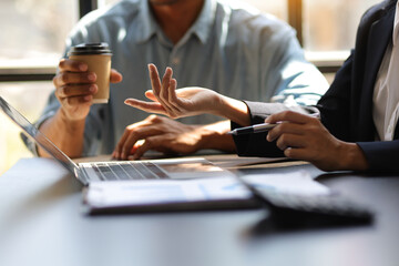 Meeting colleagues to discuss business project planning.