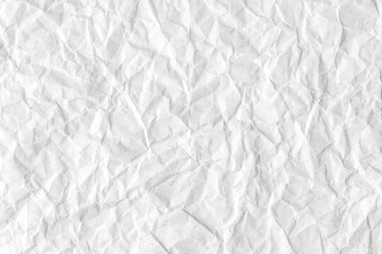 Recycled crumpled white paper texture background. Wrinkled and creased abstract backdrop, wallpaper with copy space, top view.