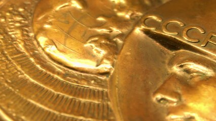 Old Soviet commemorative medal with Yuri Gagarin's profile and autograph. Macro shooting. Yuri Gagarin. - Powered by Adobe