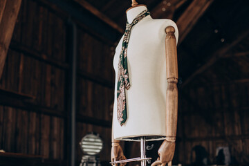 Mannequin with wedding tie on it in barn