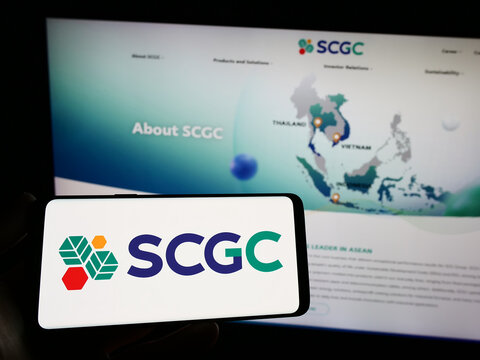 Stuttgart, Germany - 03-31-2023: Person holding smartphone with logo of Thai company SCG Chemicals (SCGC) on screen in front of website. Focus on phone display.