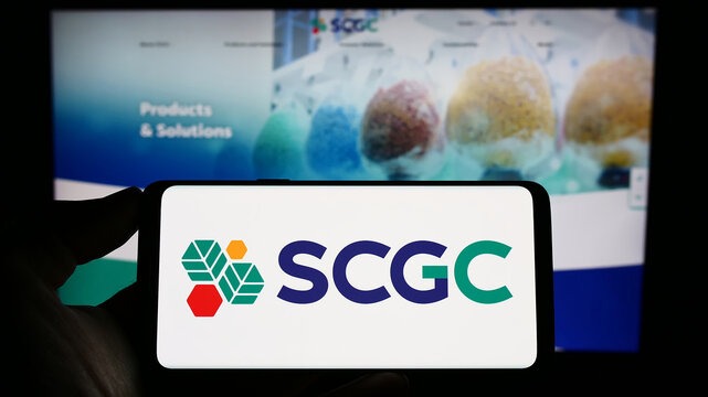 Stuttgart, Germany - 03-31-2023: Person holding cellphone with logo of Thai company SCG Chemicals (SCGC) on screen in front of business webpage. Focus on phone display.