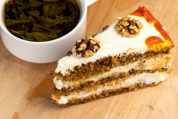 a cut piece of multi-layered honey cake with creamy filling